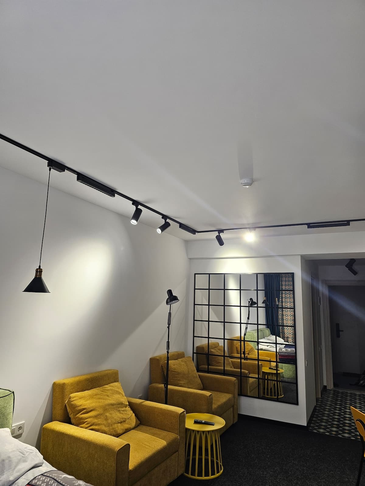 Living room with armchairs and track lighting